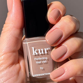 LONDONTOWN kur Perfecting Nail Veil Creamy Latté Tint on a vanity
