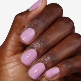LONDONTOWN kur Perfecting Nail Veil Sheer Lilac Tint on a manicure table