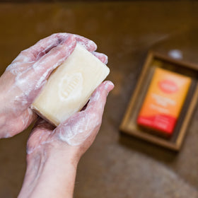 Lume Triple Milled Bar Soap Clean Tangerine lathering on skin