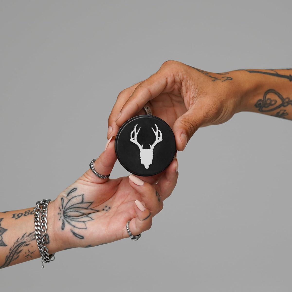Mad Rabbit Tattoo Balm packaging on a wooden surface