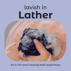 MainBasics Shower Loofah Sponge Set displayed in a bathroom setting
