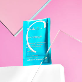 Malibu C Miracle Repair Hair Reconstructor in a bathroom setting