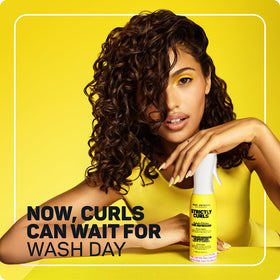 Marc Anthony Curl Refresher Spray being applied to curls