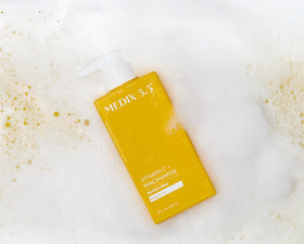 Medix 5.5 Vitamin C Body Wash on a shower shelf