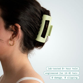 MELLO Medium Hair Clip compressing against a pillow