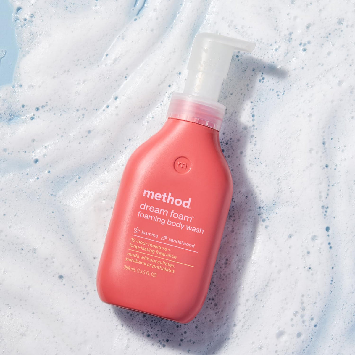 Method Dream Foam Foaming Body Wash bottle next to flowers
