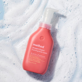 Method Dream Foam Foaming Body Wash bottle next to flowers