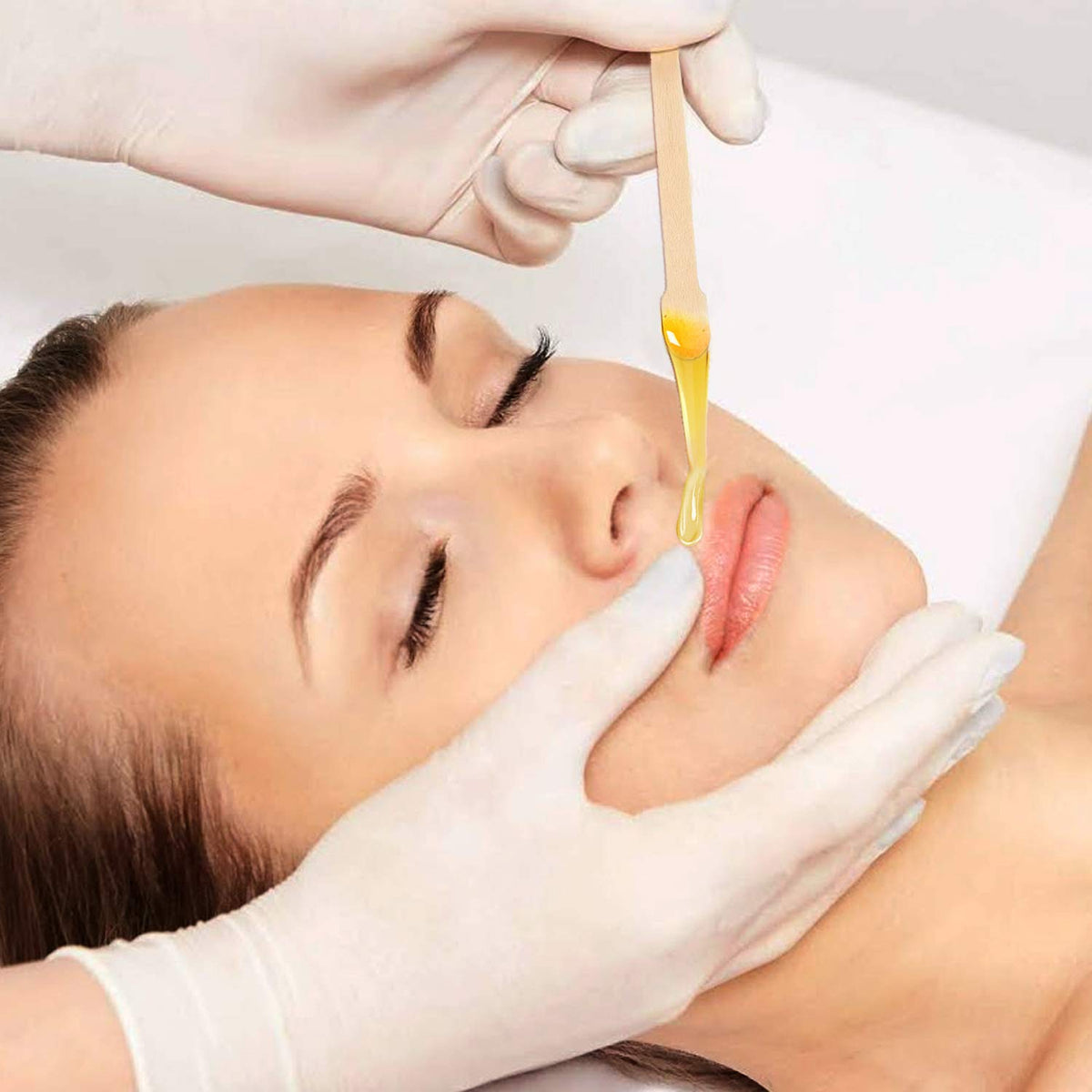Mibly wooden wax sticks in use for eyebrow waxing