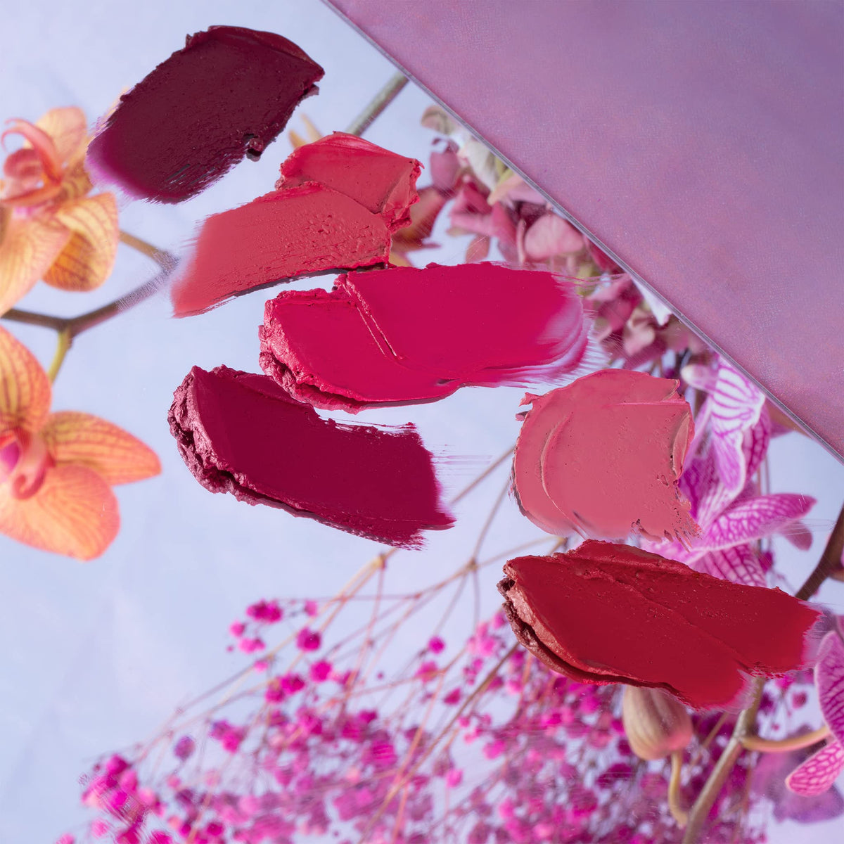 Milani Color Fetish Matte Lipstick Fleur on a vanity with makeup accessories