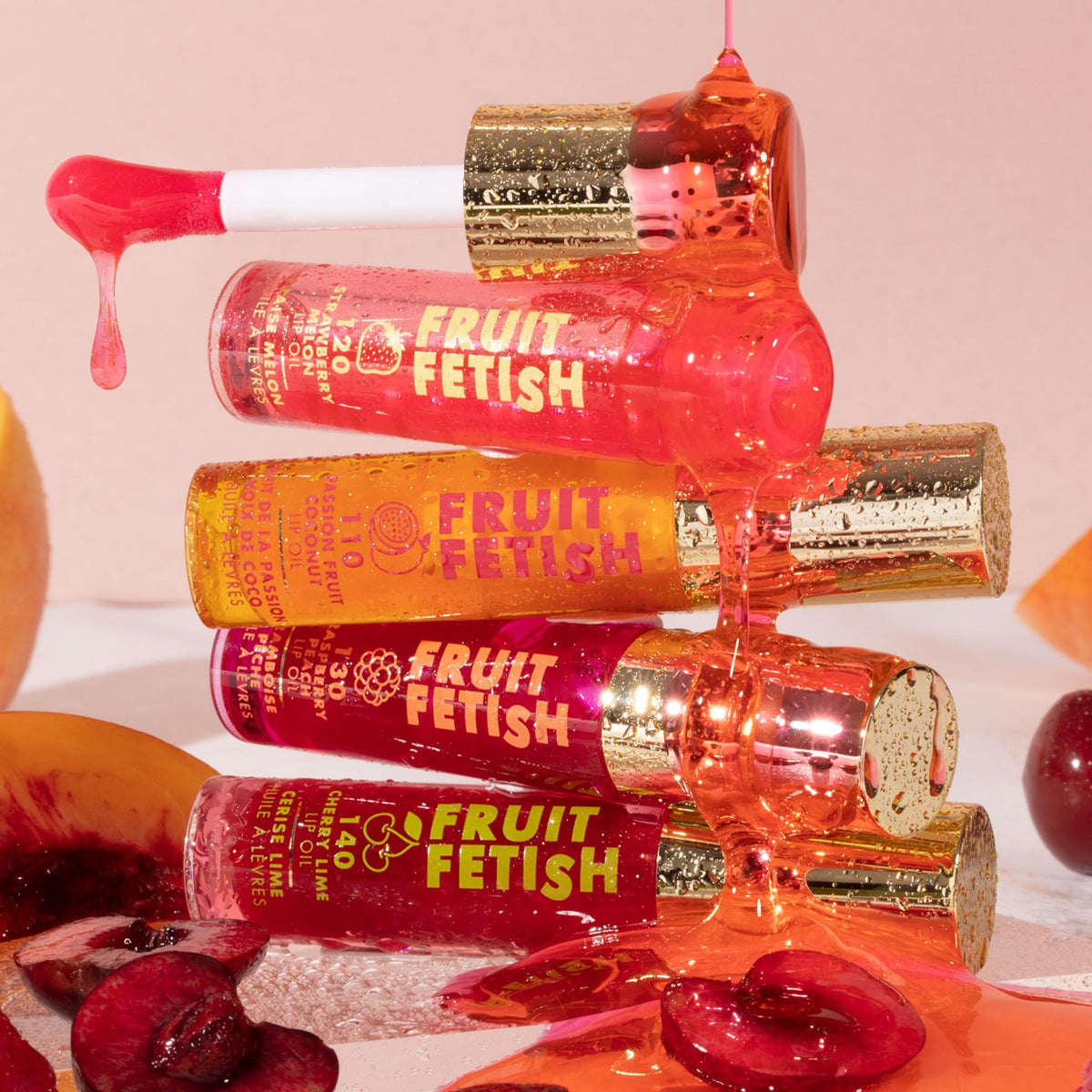 Milani Fruit Fetish Lip Oil 2pk displayed with fruits