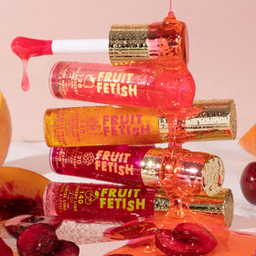 Milani Fruit Fetish Lip Oil 2pk displayed with fruits