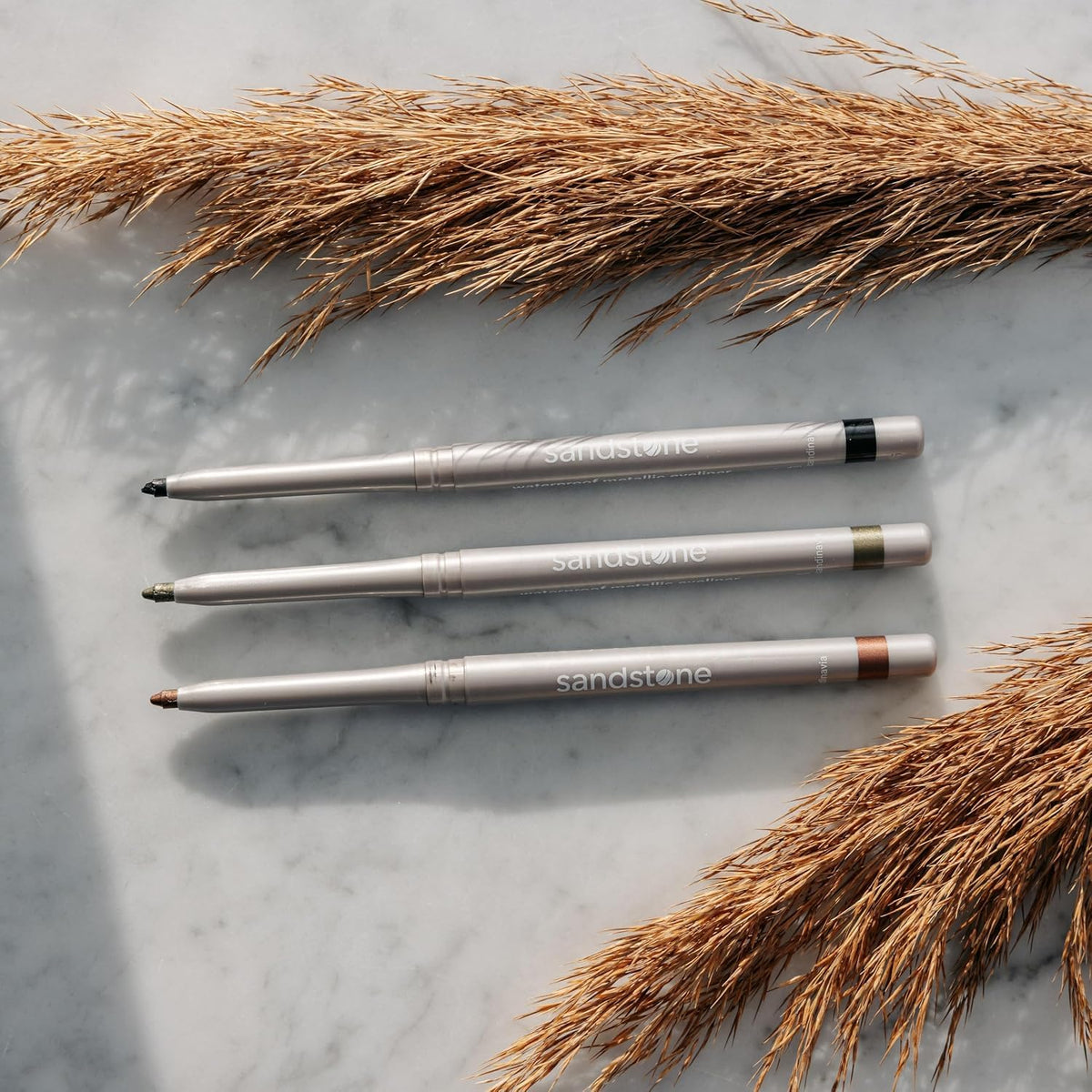 Model applying Sandstone Scandinavia Eyeliner Pencil