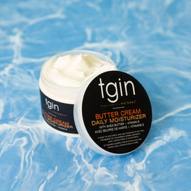 Model using Butter Cream Daily Moisturizer on curly hair