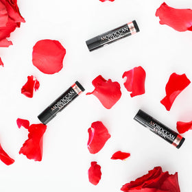 Moroccan Magic Organic Rose Lip Balm with floral background