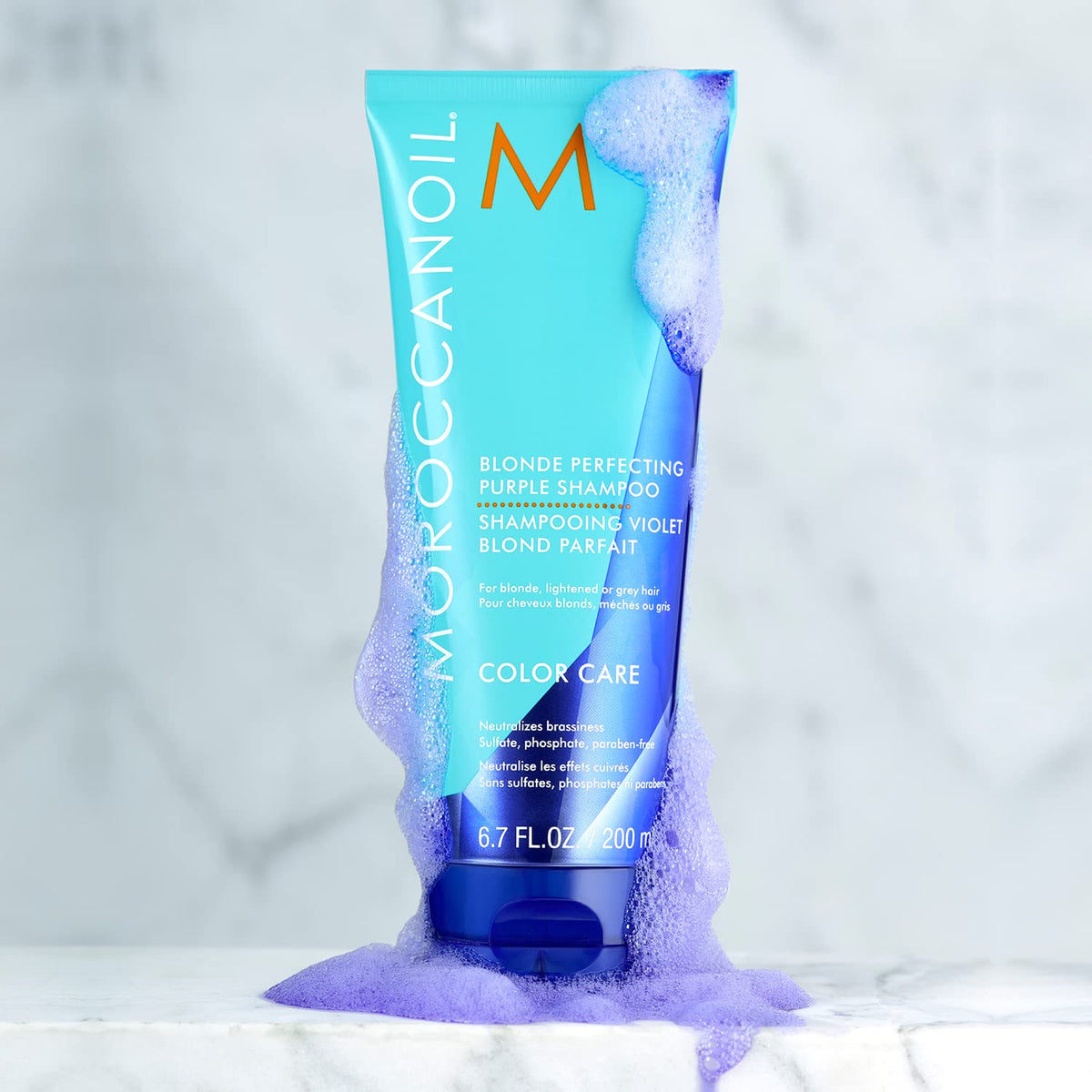 Moroccanoil Blonde Perfecting Purple Shampoo with fresh flowers