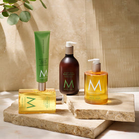 Moroccanoil Shower Gel Bergamote Fraiche surrounded by mint leaves