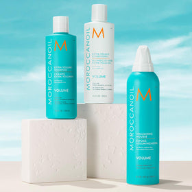 Moroccanoil Volumizing Mousse 8.5 Fl. Oz with argan oil background