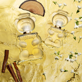 Moschino Toy 2 Eau de Parfum on a vanity with flowers
