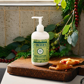 Mrs. MEYER'S Iowa Pine Hand Lotion on a wooden table