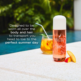 Nautica Peach Bite Body Mist 8oz bottle in a beach setting