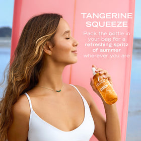 Nautica Tangerine Squeeze Body Mist 8oz on a beach towel