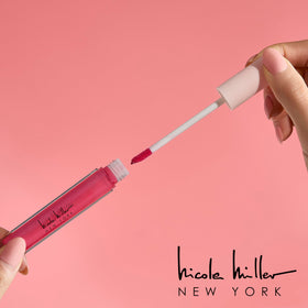 Nicole Miller Lip Gloss in flowery pink shade on lips