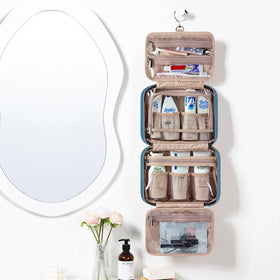 NISHEL Travel Toiletry Bag hanging on a bathroom hook