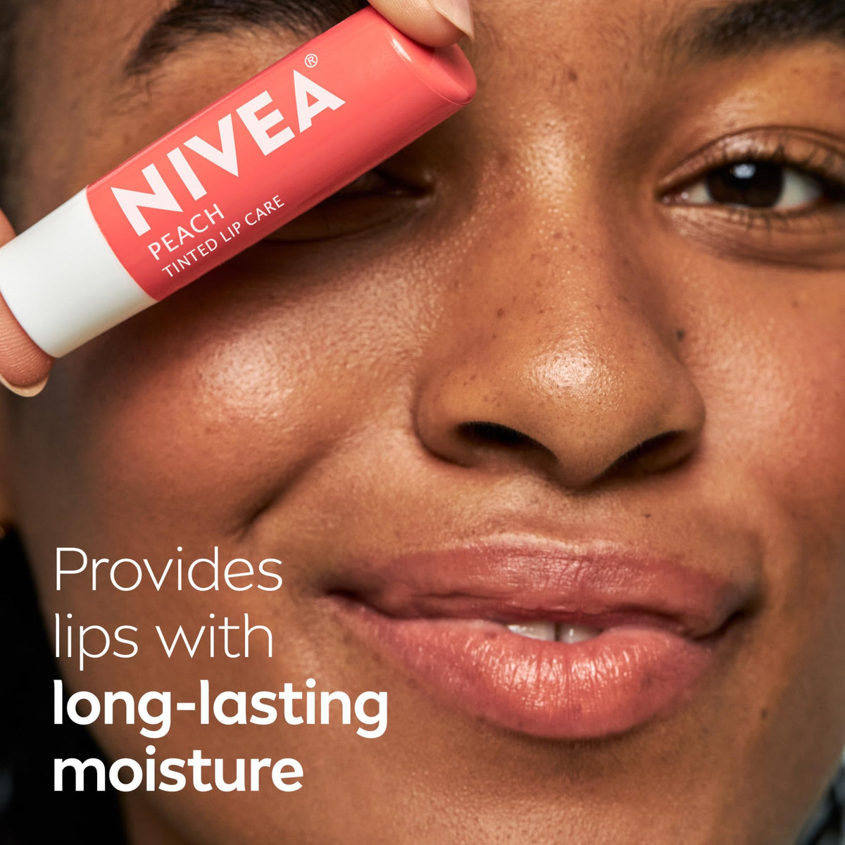 NIVEA Peach Lip Care tinted lip balm on a desk