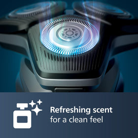 Norelco Quick Clean Pod Cartridge in use with electric shaver