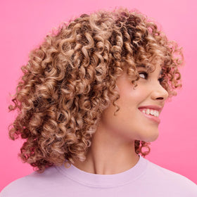 Not Your Mother's Curl Defining Shampoo and Conditioner on a bathroom shelf