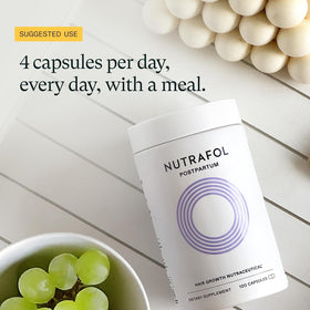 Nutrafol Postpartum Hair Growth Supplements in a bathroom setting