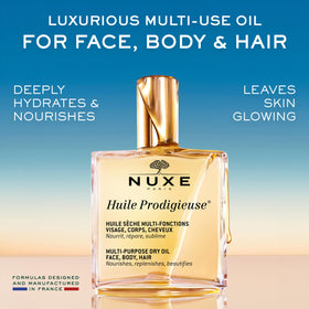 Nuxe Huile Prodigieuse bottle with botanical oils background