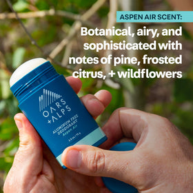 Oars + Alps Men's Deodorant stick held in hand outdoors
