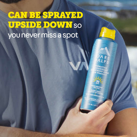 Oars + Alps SPF 30 Body Sunscreen Spray lifestyle shot with beach
