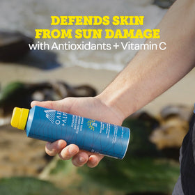 Oars + Alps sunscreen spray with summer background