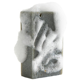 Oatmeal Shea soap bar from Crate 61 Organics on a wooden soap dish