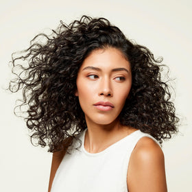 Odele Clarifying Shampoo on a bathroom shelf
