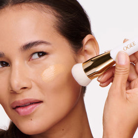 Ogee Professional Quality Makeup Brush in lifestyle setting with makeup products