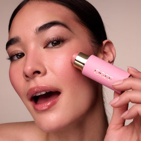 Ogee Sculpted Face Stick Pink Diamond texture on hand