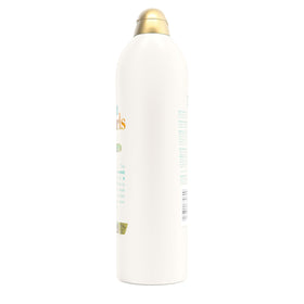 OGX Quenching + Coconut Curls Shampoo with tropical background