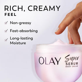 Olay Super Serum Body Cream 10 fl oz with flowers and soft wood background
