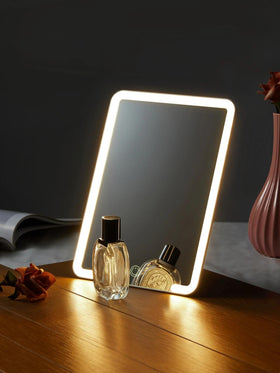 OMIRO Lighted Makeup Mirror in a vanity setup with beauty tools
