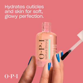 OPI Glow Up Nail & Cuticle Oil on a wooden table