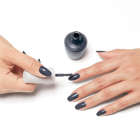OPI Nature Strong Dark Blue Crème Nail Polish on a vanity
