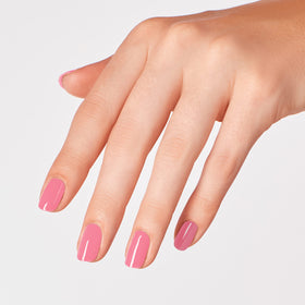 OPI Racing for Pinks nail polish bottle with a background of nail art