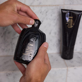 ORIBE Signature Shampoo 8.5oz with lather on hair