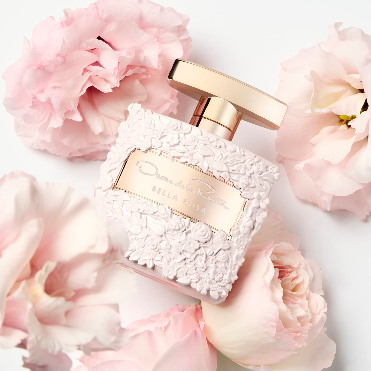 Oscar de la Renta Bella Rosa Eau de Parfum bottle with floral background