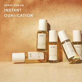 OUAI St. Barts Hair and Body Mist bottle with tropical background