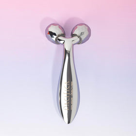 Pacifica Future Youth Face Roller beside skincare products