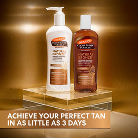 Palmer's Cocoa Butter Formula Sunless Tanning Oil in hand